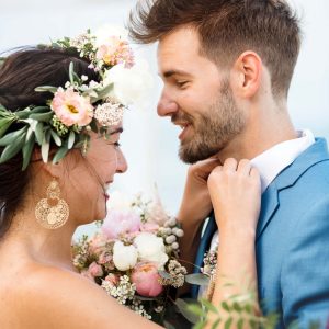 young-couple-in-a-wedding-ceremony-at-the-beach-MPTK5HL-scaled.jpg